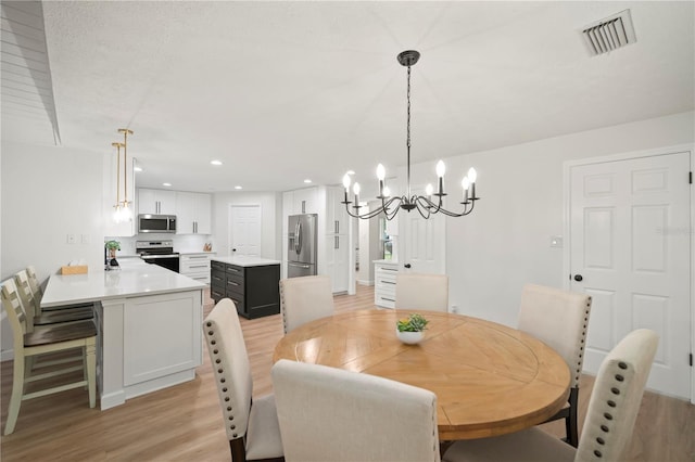 22238 River Rock Dr, Land O Lakes, FL 34639 - dining space featuring light wood-type flooring, a chandelier, and recessed lighting