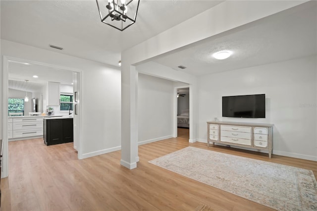 22238 River Rock Dr, Land O Lakes, FL 34639 - unfurnished living room with light wood-style floors and baseboards