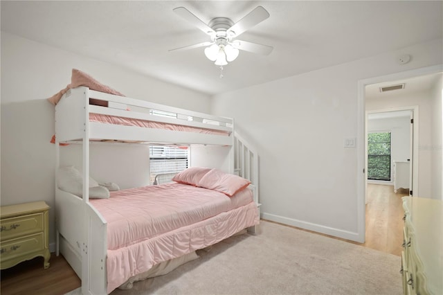 22238 River Rock Dr, Land O Lakes, FL 34639 - bedroom featuring multiple windows, wood finished floors, and ceiling fan