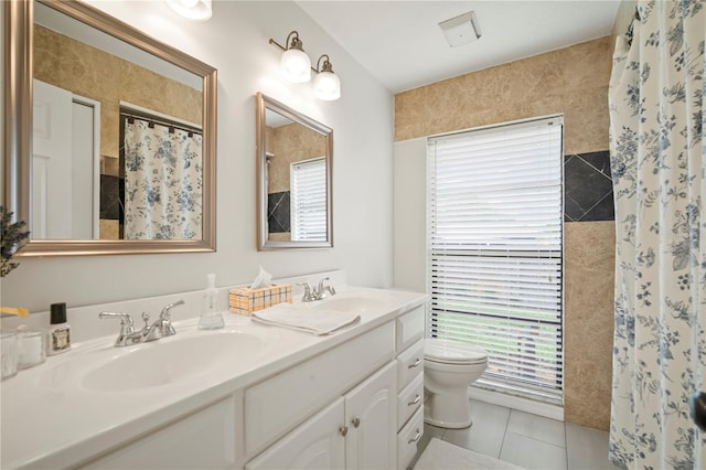 22238 River Rock Dr, Land O Lakes, FL 34639 - full bathroom featuring healthy amount of natural light, double vanity, a shower with curtain, and tile patterned flooring