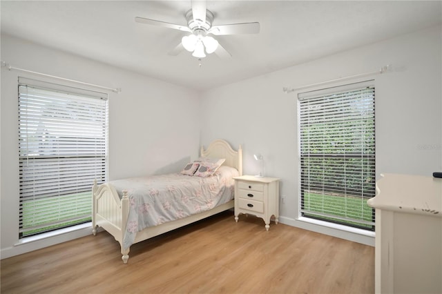 22238 River Rock Dr, Land O Lakes, FL 34639 - bedroom featuring light wood-type flooring, multiple windows, and ceiling fan
