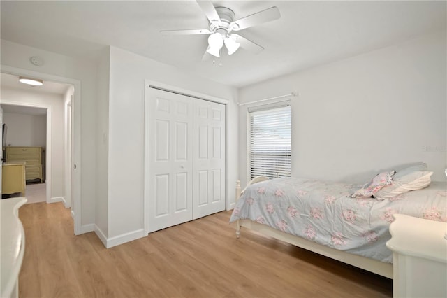 22238 River Rock Dr, Land O Lakes, FL 34639 - bedroom featuring wood finished floors, a closet, and a ceiling fan