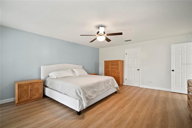 22238 River Rock Dr, Land O Lakes, FL 34639 - bedroom with light wood-style floors and a ceiling fan