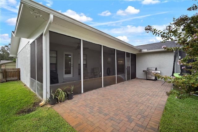 22238 River Rock Dr, Land O Lakes, FL 34639 - rear view of property with a sunroom, stucco siding, and a patio