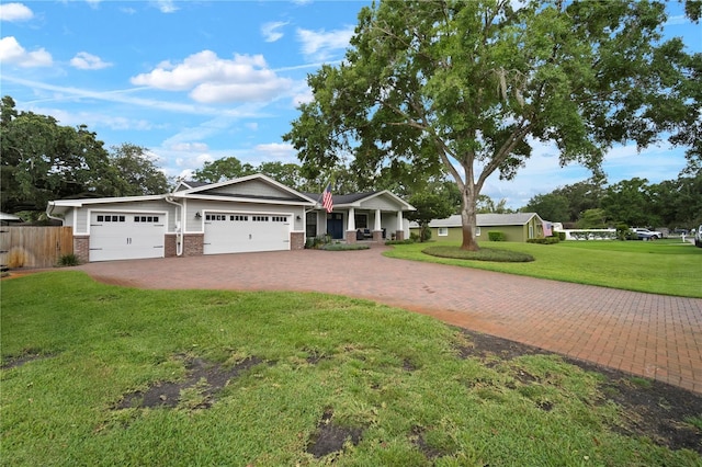 22238 River Rock Dr, Land O Lakes, FL 34639 - craftsman-style home with decorative driveway, brick siding, and an attached garage