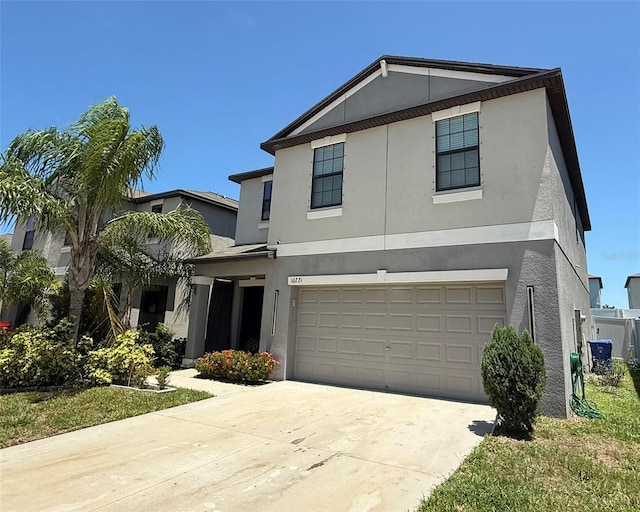10221 Carloway Hills Dr, Wimauma, FL 33598 - traditional-style home with stucco siding, concrete driveway, and an attached garage