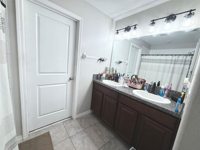 10221 Carloway Hills Dr, Wimauma, FL 33598 - bathroom featuring double vanity, tile patterned flooring, and a shower with curtain