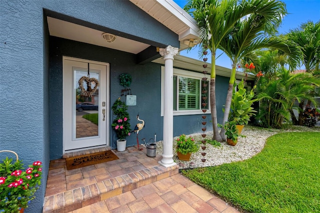 621 77th Ave, St Pete Beach, FL 33706 - view of exterior entry featuring stucco siding
