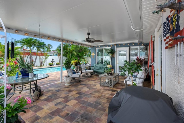 621 77th Ave, St Pete Beach, FL 33706 - fenced backyard featuring area for grilling, a ceiling fan, and a patio