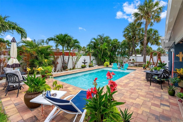 621 77th Ave, St Pete Beach, FL 33706 - view of swimming pool with a patio area, a fenced backyard, and outdoor dining area
