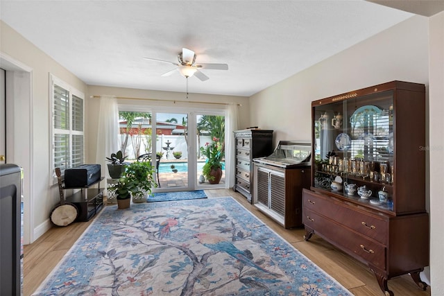 621 77th Ave, St Pete Beach, FL 33706 - living area with ceiling fan and light wood-style flooring