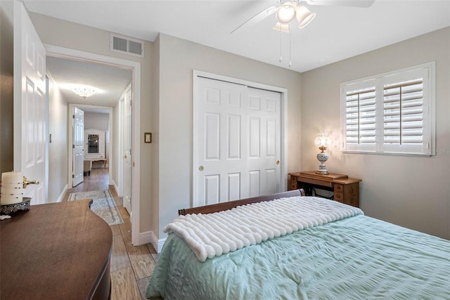 621 77th Ave, St Pete Beach, FL 33706 - bedroom with light wood finished floors, a closet, and a ceiling fan