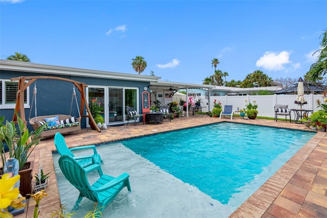 621 77th Ave, St Pete Beach, FL 33706 - view of pool with a ceiling fan, outdoor lounge area, a patio area, and a fenced backyard