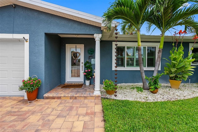 621 77th Ave, St Pete Beach, FL 33706 - entrance to property featuring stucco siding and an attached garage