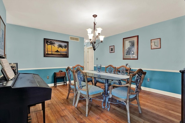 101 Carlyle Dr, Palm Harbor, FL 34683 - dining area featuring a chandelier and wood finished floors