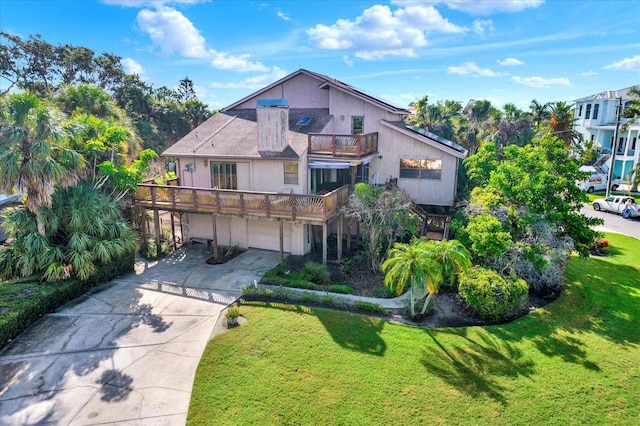 101 Carlyle Dr, Palm Harbor, FL 34683 - view of front of house featuring a balcony, a garage, concrete driveway, and a front lawn