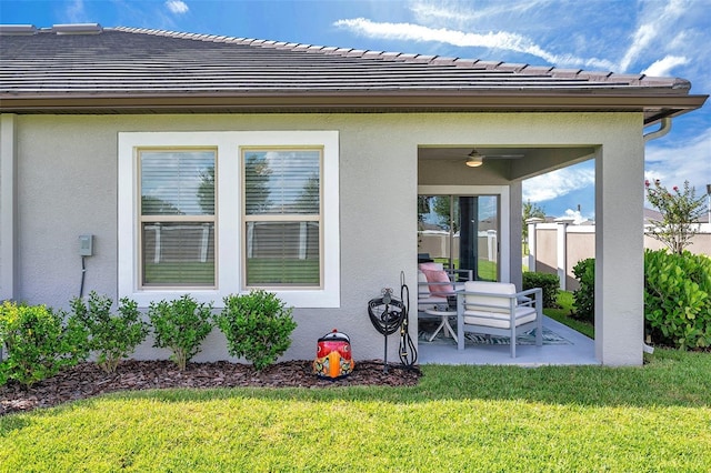 31530 Magna Gulf Loop, San Antonio, FL 33576 - rear view of property with ceiling fan, a lawn, a patio, stucco siding, and a tile roof