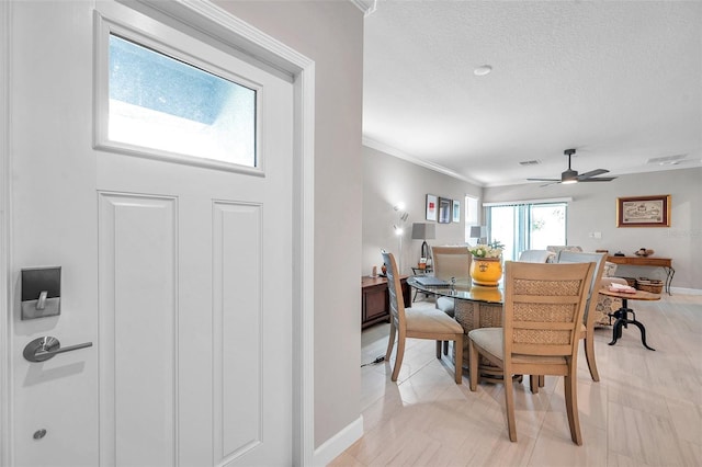 31530 Magna Gulf Loop, San Antonio, FL 33576 - dining room with ceiling fan, a textured ceiling, and crown molding