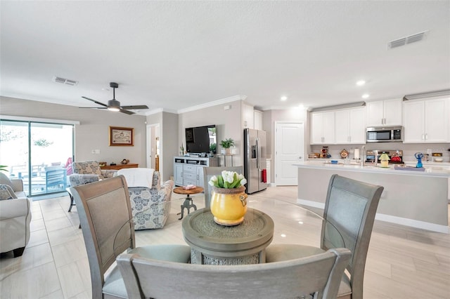 31530 Magna Gulf Loop, San Antonio, FL 33576 - dining area with ornamental molding, a ceiling fan, and recessed lighting
