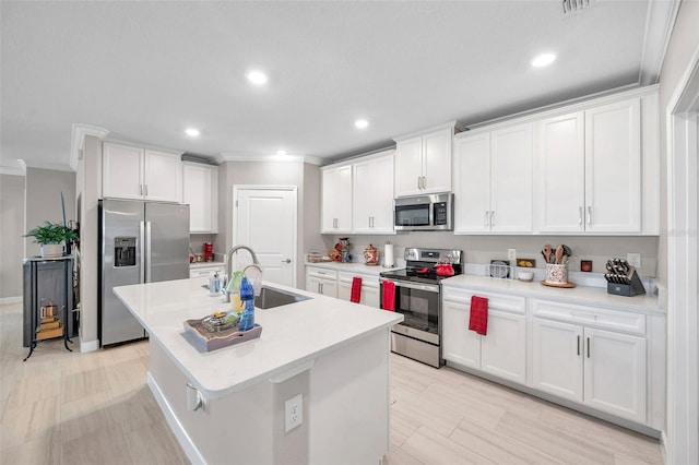 31530 Magna Gulf Loop, San Antonio, FL 33576 - kitchen featuring stainless steel appliances, ornamental molding, recessed lighting, white cabinetry, and a center island with sink