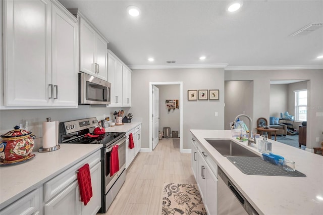 31530 Magna Gulf Loop, San Antonio, FL 33576 - kitchen featuring stainless steel appliances, crown molding, white cabinetry, and recessed lighting