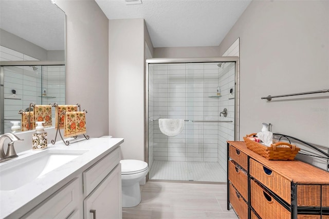 31530 Magna Gulf Loop, San Antonio, FL 33576 - full bathroom with vanity, a shower stall, and a textured ceiling