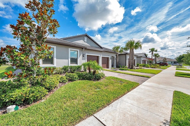 31530 Magna Gulf Loop, San Antonio, FL 33576 - ranch-style home with stucco siding, an attached garage, decorative driveway, and a front lawn
