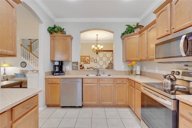 8251 118th Ave Unit 8251, Largo, FL 33773 - kitchen featuring stainless steel appliances, light countertops, crown molding, arched walkways, and light tile patterned floors