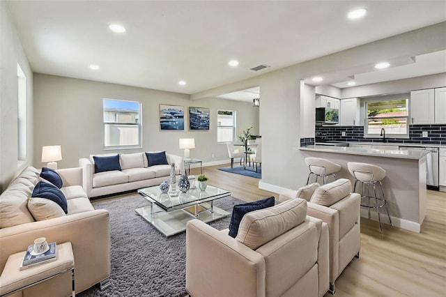 7806 N Matanzas Ave, Tampa, FL 33614 - living area featuring light wood finished floors and recessed lighting