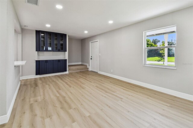7806 N Matanzas Ave, Tampa, FL 33614 - unfurnished living room featuring recessed lighting and light wood-style flooring