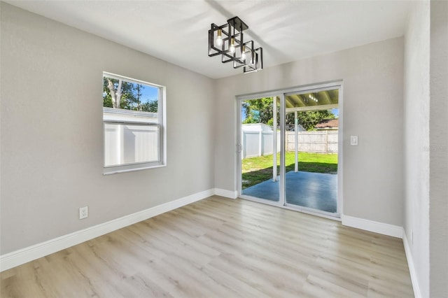 7806 N Matanzas Ave, Tampa, FL 33614 - empty room featuring wood finished floors and healthy amount of natural light
