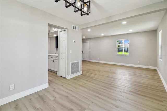 7806 N Matanzas Ave, Tampa, FL 33614 - unfurnished room with a chandelier, recessed lighting, and light wood-style flooring