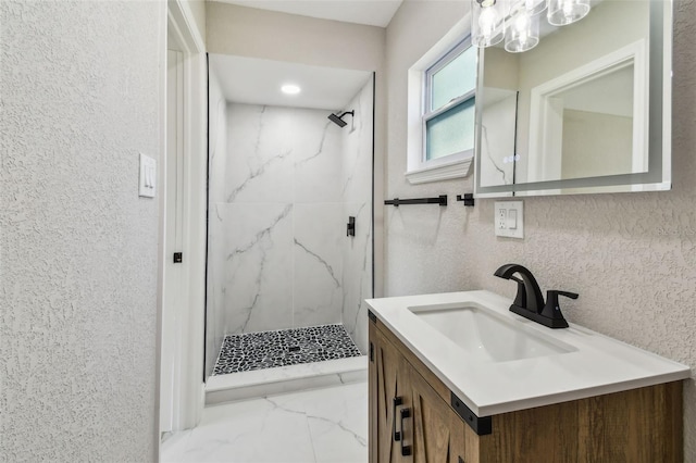 7806 N Matanzas Ave, Tampa, FL 33614 - bathroom featuring a marble finish shower, vanity, marble look tile flooring, and a chandelier
