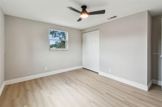 7806 N Matanzas Ave, Tampa, FL 33614 - unfurnished bedroom featuring a closet, wood finished floors, and a ceiling fan