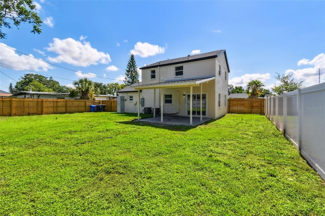 7806 N Matanzas Ave, Tampa, FL 33614 - rear view of house with a patio, stucco siding, a fenced backyard, and a shingled roof
