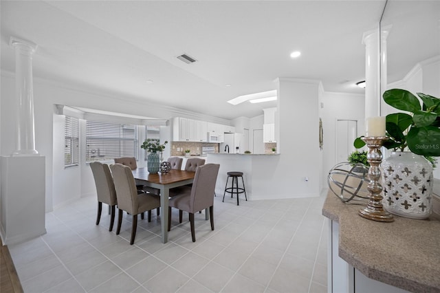1760 W Shanelle Path, Lecanto, FL 34461 - dining space featuring decorative columns, ornamental molding, light tile patterned floors, and vaulted ceiling