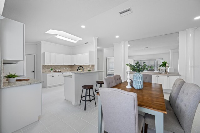 1760 W Shanelle Path, Lecanto, FL 34461 - dining room featuring crown molding, a skylight, light tile patterned flooring, and recessed lighting