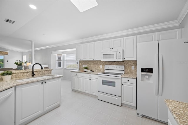 1760 W Shanelle Path, Lecanto, FL 34461 - kitchen with white appliances, ornamental molding, plenty of natural light, light tile patterned flooring, and white cabinetry