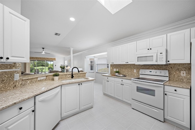 1760 W Shanelle Path, Lecanto, FL 34461 - kitchen with white appliances, lofted ceiling, decorative backsplash, white cabinets, and crown molding