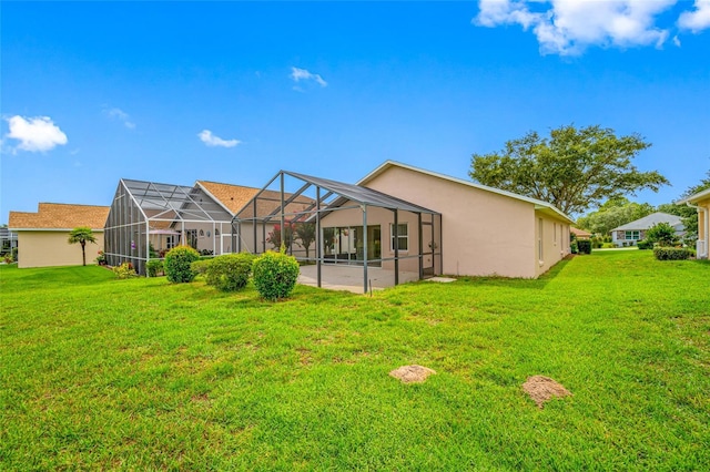 1760 W Shanelle Path, Lecanto, FL 34461 - rear view of house with a lawn, stucco siding, and glass enclosure