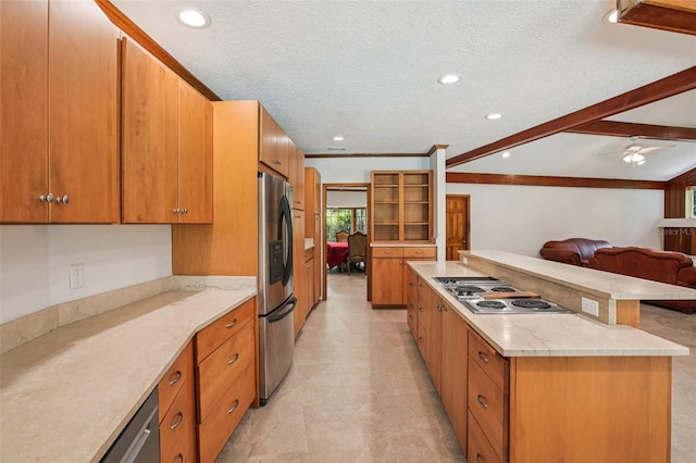 4128 Carrollwood Village Dr, Tampa, FL 33618 - kitchen featuring stainless steel refrigerator with ice dispenser, electric cooktop, a center island, open floor plan, and brown cabinets
