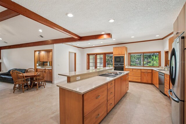 4128 Carrollwood Village Dr, Tampa, FL 33618 - kitchen with black appliances, a kitchen island, recessed lighting, light stone countertops, and open floor plan