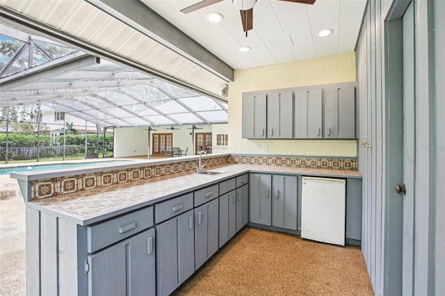 4128 Carrollwood Village Dr, Tampa, FL 33618 - kitchen featuring gray cabinets, a peninsula, ceiling fan, light countertops, and recessed lighting