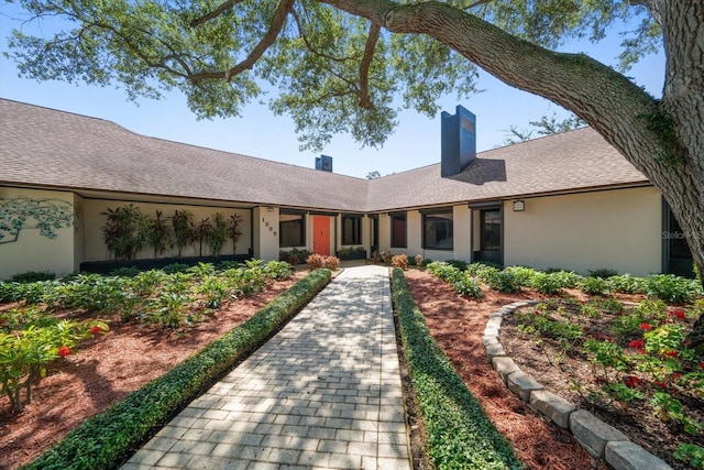 1835 Alicia Way, Clearwater, FL 33764 - ranch-style house featuring a chimney, stucco siding, and roof with shingles