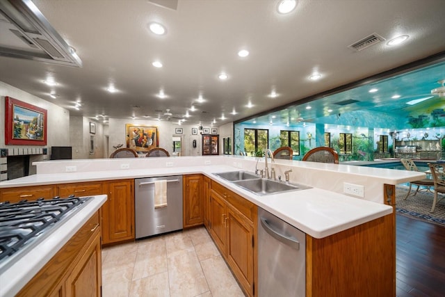 1835 Alicia Way, Clearwater, FL 33764 - kitchen featuring stainless steel appliances, light countertops, brown cabinetry, and recessed lighting