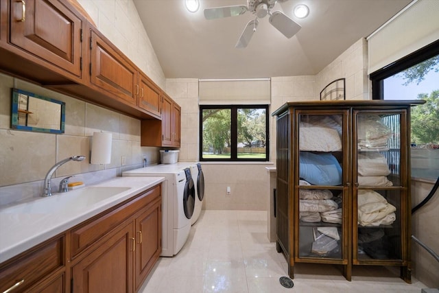 1835 Alicia Way, Clearwater, FL 33764 - laundry area with washing machine and clothes dryer, tile walls, a ceiling fan, light tile patterned floors, and plenty of natural light