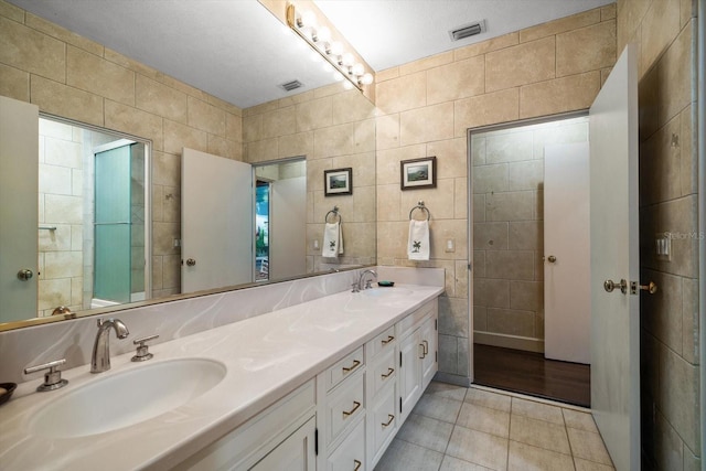 1835 Alicia Way, Clearwater, FL 33764 - full bath featuring tile walls, tile patterned flooring, and double vanity