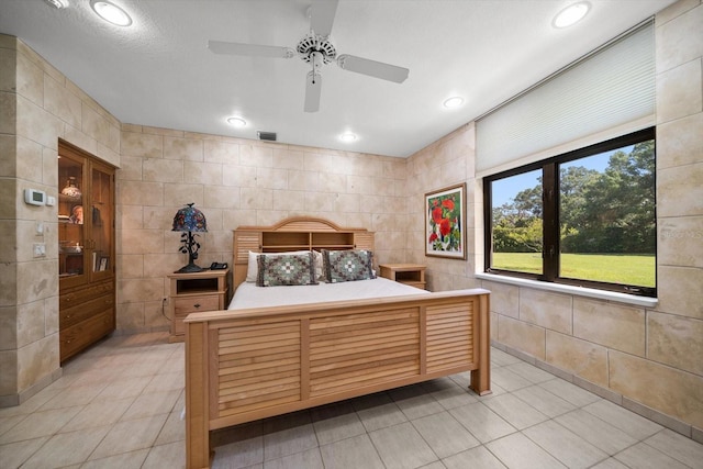 1835 Alicia Way, Clearwater, FL 33764 - bedroom with light tile patterned flooring, tile walls, recessed lighting, and ceiling fan