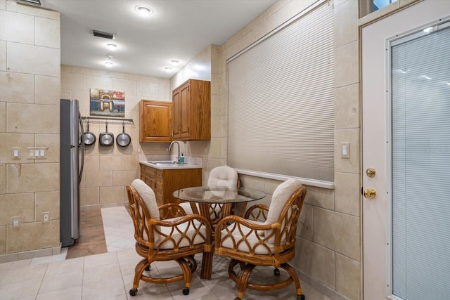 1835 Alicia Way, Clearwater, FL 33764 - dining space featuring light tile patterned floors and tile walls