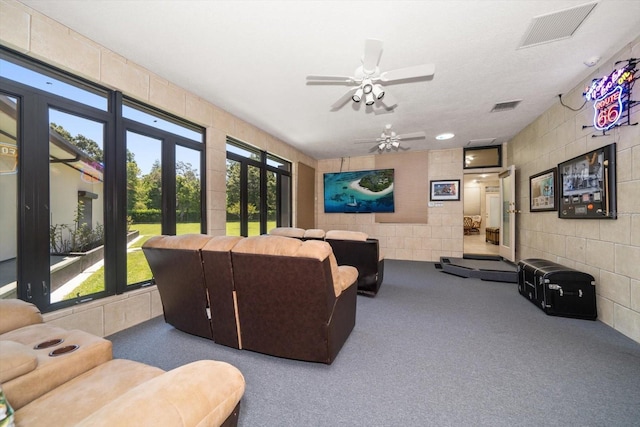 1835 Alicia Way, Clearwater, FL 33764 - living room featuring carpet flooring, a ceiling fan, and tile walls